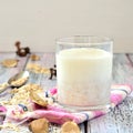 Oat milk in a glass on the table with fruit