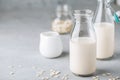 Oat Milk in glass. Vegan non dairy oat milk on gray stone background