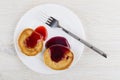 Oat pancakes with blueberry jam, strawberry jam in plate, fork Royalty Free Stock Photo