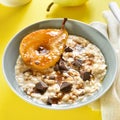 Oat porridge with caramelized pear and chocolate pieces Royalty Free Stock Photo