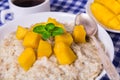 Oat porridge with fresh mango in the white bowl with coffee Royalty Free Stock Photo