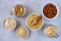 Oat products assortment in bowls. Granola, rolled oats, bran , flour and raw oat seeds . Top view