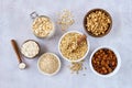 Oat products assortment in bowls. Granola, rolled oats, bran , flour and raw oat seeds . Top view