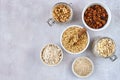 Oat products assortment in bowls. Granola, rolled oats, bran , flour and raw oat seeds . Top view