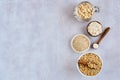 Oat products assortment in bowls. Rolled oats, bran , flour and raw oat seeds . Top view