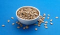 Oat rye flakes in bowl isolated on blue color background Royalty Free Stock Photo