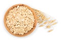 Oat spike with oat flakes in wooden bowl isolated on white background. Top view. Flat lay Royalty Free Stock Photo