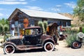 OATMAN ARIZONA, USA - AUGUST 7. 2009: American vintage car in front of abandoned wooden historic old gas station