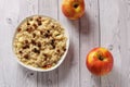 Oatmeal with apple and raisins against the background of the old tree. Muesli with an apple and raisins Royalty Free Stock Photo