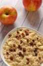 Oatmeal with apple and raisins against the background of the old tree. Muesli with an apple and raisins Royalty Free Stock Photo