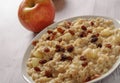 Oatmeal with apple and raisins against the background of the old tree. Muesli with an apple and raisins Royalty Free Stock Photo
