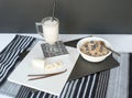 Oatmeal with Blueberries and Vanilla Banana Smoothie on White with Black Background