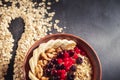 Oatmeal in bowl with berries, bananas and walnuts Royalty Free Stock Photo