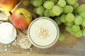 Oatmeal breakfast smoothie with grapes, pear and yogurt in top view