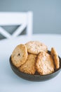 Oatmeal broun homemade cookies in plate on white table. Healhy desserts, diet