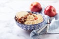 Oatmeal with caramelized apples with cinnamon, banana and grated strawberries Royalty Free Stock Photo