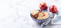 Oatmeal with caramelized apples with cinnamon, banana and grated strawberries Royalty Free Stock Photo