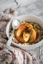 Oatmeal with caramelized apples and cinnamon in a white bowl