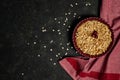 Oatmeal cherry crumble on a dark background. Place for text. View from above.