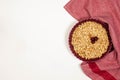 Oatmeal cherry crumble on a white background. Place for text. View from above.