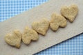 Oatmeal and coconut flakes heart cookies on cutting board Royalty Free Stock Photo