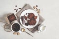 Oatmeal cookies with cocoa and chocolate on a white plate and in a cardboard box, cup of coffee and a milk jug Royalty Free Stock Photo