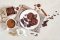 Oatmeal cookies with cocoa and chocolate on a white plate and in a cardboard box, cup of coffee and a milk jug Royalty Free Stock Photo