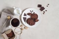 Oatmeal cookies with cocoa and chocolate on a white plate and in a cardboard box, cup of coffee and a milk jug Royalty Free Stock Photo