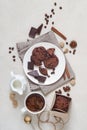 Oatmeal cookies with cocoa and chocolate on a white plate and in a cardboard box, cup of coffee and a milk jug Royalty Free Stock Photo