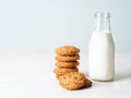 Oatmeal cookies with flax seeds and milk in bottle, healthy snack. Light background, grey light wall Royalty Free Stock Photo