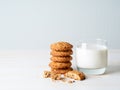 Oatmeal cookies with flax seeds and milk in a glass, healthy snack. Light background, grey light wall Royalty Free Stock Photo