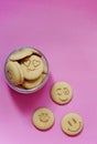 Oatmeal cookies in the form of an emoticon on a pink background. Shortbread cookie for breakfast. Baby biscuits for snacks