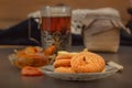 Oatmeal cookies, jam and a glass of hot tea in an antique silver cup holder on a gray wooden table. Royalty Free Stock Photo