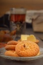 Oatmeal cookies, jam and a glass of hot tea in an antique silver cup holder on a gray wooden table. Royalty Free Stock Photo