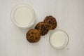 Oatmeal cookies and milk on a white wood background