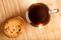 Oatmeal cookies with pieces of chocolate and a mug of coffee on a bamboo stand. Close-up Royalty Free Stock Photo