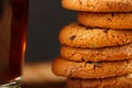 Oatmeal cookies with pieces of chocolate and a mug of coffee on a bamboo stand. Macro Royalty Free Stock Photo