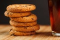 Oatmeal cookies with pieces of chocolate and a mug of coffee on a bamboo stand. Macro Royalty Free Stock Photo