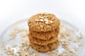 Oatmeal cookies tower made with oat flakes on plate on white background. Healthy food for breakfast or a snack. Close up. Soft Royalty Free Stock Photo