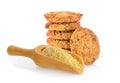 Oatmeal cookies and wheat germ in wood scoop on white background