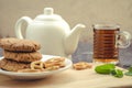 Oatmeal cookies on a wooden table and tea with mint/oatmeal cookies on a wooden table and tea with mint. Selective focus Royalty Free Stock Photo