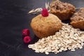 Oatmeal cupcakes and fresh raspberry berries on dark black background Royalty Free Stock Photo