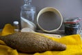 Oatmeal diet bread on a yellow towel in the background is satiated for flour, a jar of flour, spices and a spoon