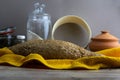 Oatmeal diet bread on a yellow towel in the background is satiated for flour, a jar of flour, spices and a spoon