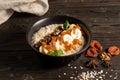 Oatmeal with dried apricots, banana and walnuts, cooked in milk and decorated with mint chanterelles. Healthy diet vegetarian brea Royalty Free Stock Photo