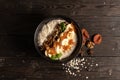 Oatmeal with dried apricots, banana and walnuts, cooked in milk and decorated with mint chanterelles. Healthy diet vegetarian brea Royalty Free Stock Photo