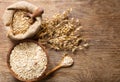 Oatmeal flakes, grains and ears of oats on wooden table Royalty Free Stock Photo