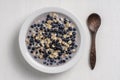 Oatmeal with fresh blueberry, almond milk and honey for breakfast in plate on wooden background. Rustic style. Top view Royalty Free Stock Photo