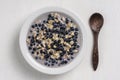 Oatmeal with fresh blueberry, almond milk and honey for breakfast in plate on wooden background. Rustic style. Top view Royalty Free Stock Photo