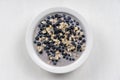 Oatmeal with fresh blueberry, almond milk and honey for breakfast in plate on wooden background. Rustic style. Top view Royalty Free Stock Photo